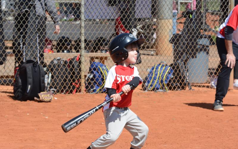 Harry Gordon heaves a bat as he eyes the incoming baseball