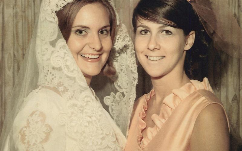 Bride Pam Shirah shares a smile with her maid of honor, Judy Mizell, on Aug. 23, 1969. Today, Pam S. NeSmith and Judy M. Wolbe celebrate a collective 102 years of marriage to the men they dated in college.