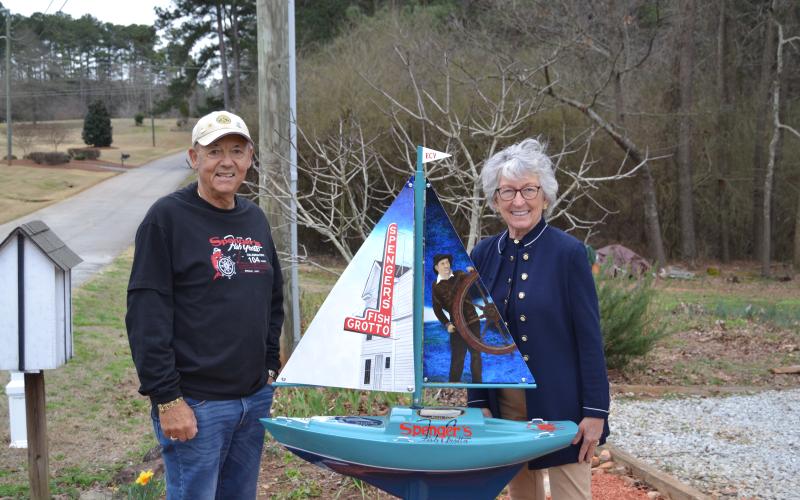 Sunshot by Drew Dotson - Frank, left, and Sandra, right, Spenger pose for a photo with a sailboat honoring the memory of Frank’s family restaurant, Spenger’s Fish Grotto.