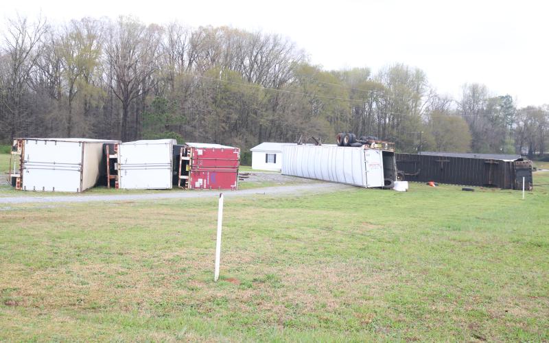 Sunshot by Grayson Williams - A row of shipping containers in front of a residence on Bio Church Road, shown above, were toppled by high winds after a series of storms swept the area March 25 and early March 26.