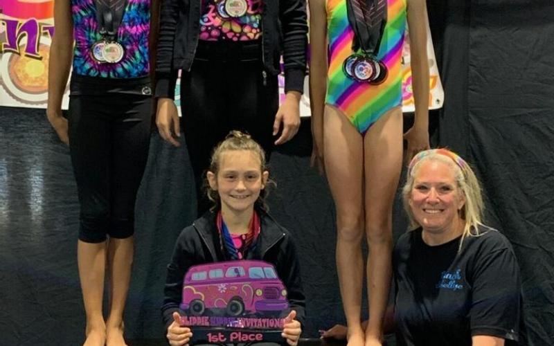 Pictured at right is the USAG level 5 Hartwell Twisters first-place team. Pictured from left to right, standing, Cheyenne Rucker, Kailyn Bowers, Maddie Dault, seated, Maci Dudley and coach Shellye Ayers.