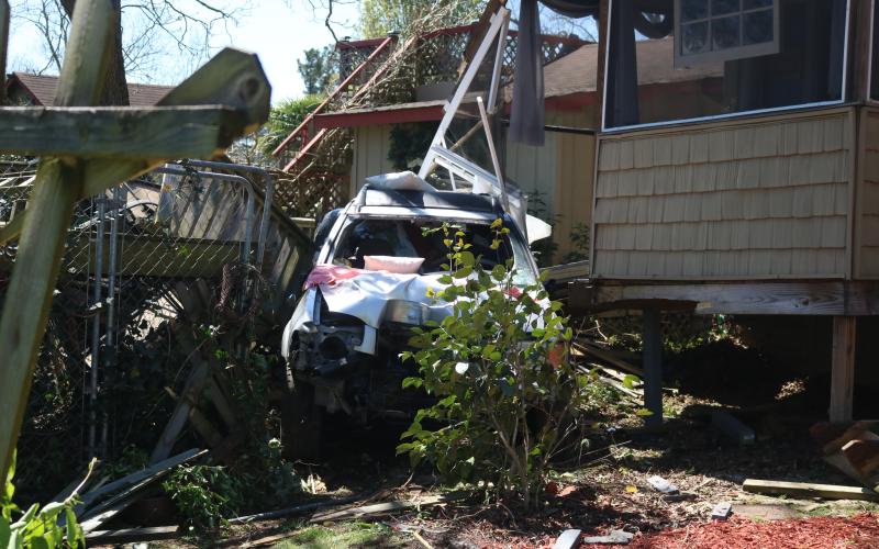 Sunshot by Grayson Williams - A car that went through a power pole and multiple fences before crashing into the rear of a residence on Royston Highway is pictured.
