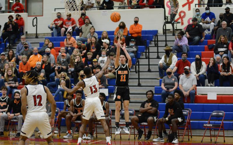J.C. Curry puts up a three pointer against Sandy Creek on March 5, at Sandy Creek High School.