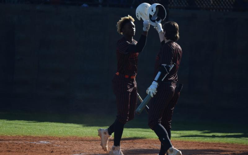 Photo by Shane Scoggins/Franklin County Citizen Leader Hart County players Malachi Thomas, left, and Casey Tallent, right, bump helmets in celebration during a double-header on Friday, April 2 at Franklin County.