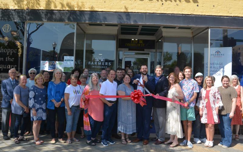 Sunshot by Drew Dotson - Farmer’s Insurance agent Major Harris cut the ribbon to celebrate the opening of his new office on April 6.