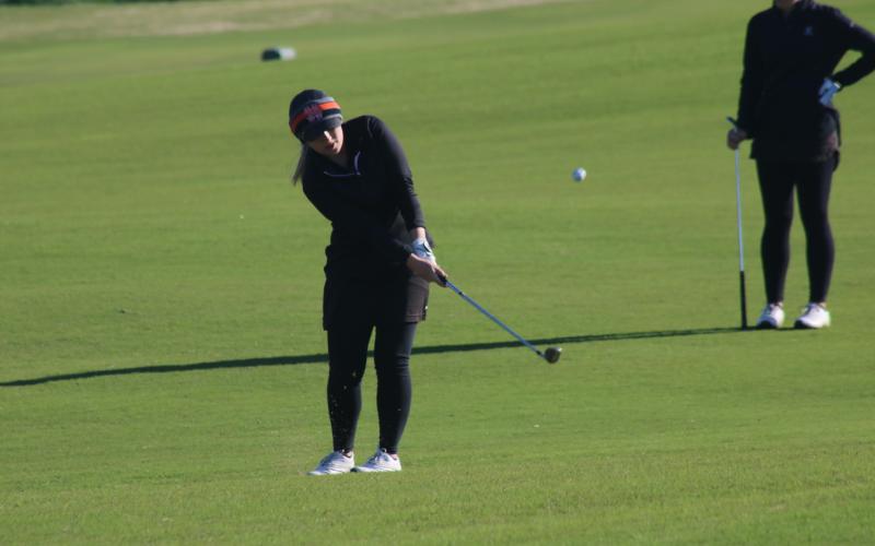 Sunshot by Grayson Williams Lauren Weaver chips a shot towards the green during a match at Cateechee on Thursday, April 1.