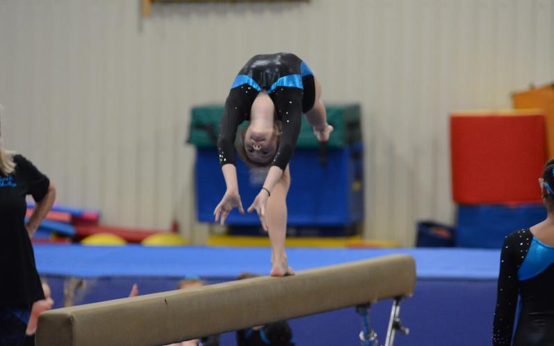 Sunshot by Grayson Williams Bella Beck bends backwards during her beam routine at the Bell Family YMCA on Friday, April 16.