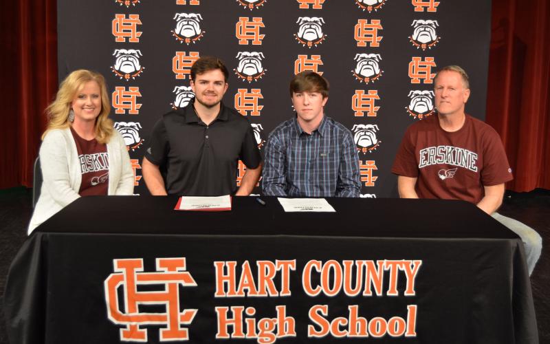Sunshot by Drew Dotson - Max Heaton, second from right, poses for a photo with his parents Kevin, far right, and Jennifer Heaton, far left, alongside Erskine head bass fishing coach Ryan Teems, second from left, after Max signed a letter of intent on Friday, April 2 at Hart County High School to fish collegiately for Erskine College.