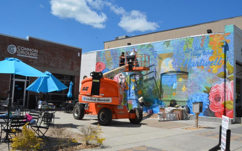Color the World Bright, a organization of art students from the Lamar Dodd School of Art at the University of Georgia, add a splash of color to the wall of the Hart County Chamber of Commerce building with a new mural.