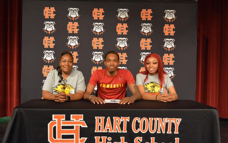 Sunshot by Drew Dotson - Shone “Spudd” Webb, middle,  signed to play collegiate basketball next to his  mom Shelle Smith, left  and his sister Tyia Webb, right.