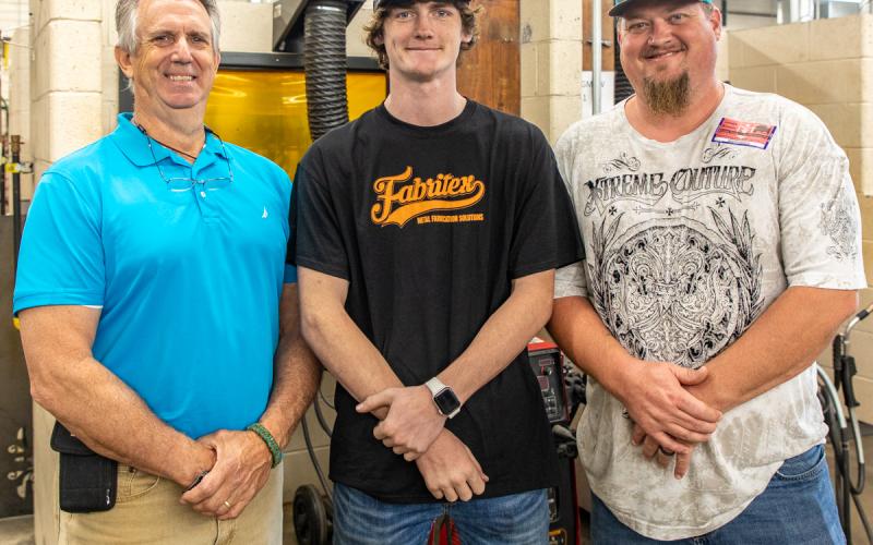 Photo submitted - Welding student Austin Brown recently took home first place in a welding competition. Pictured from left to right are welding instructor Mike Carey, Austin Brown, and Austin’s father, Ryan.