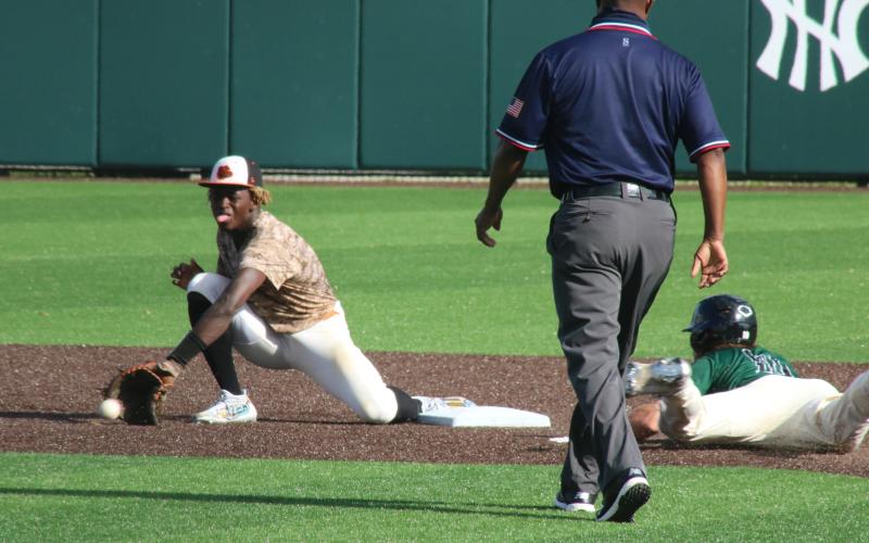 Grayson Williams/The Hartwell Sun Hart County’s Malachi Thomas digs for a throw and attempts to tag out a North Hall baserunner on Wednesday, May 5 in Gainesville.