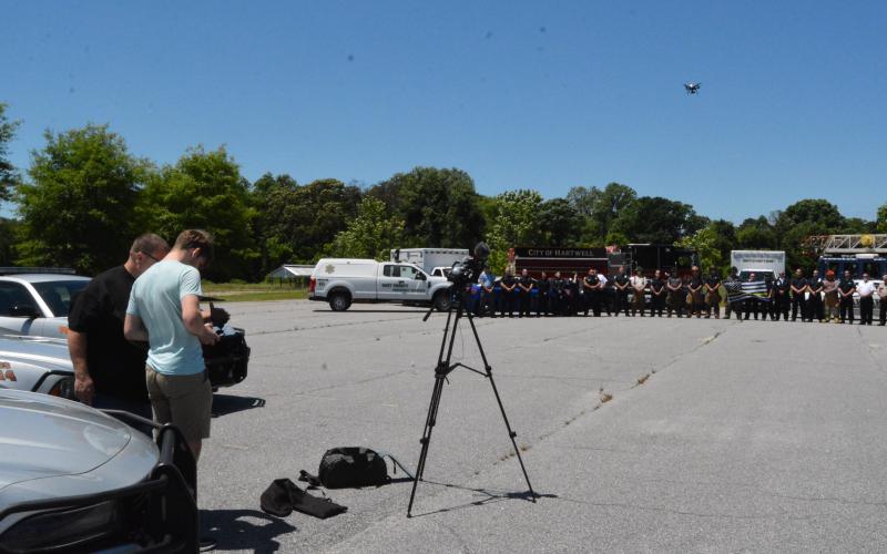 Drew Dotson/The Hartwell Sun Hart County High School media instructor Greg Gaines, left,  directs drone pilot Adian Stovall on how to capture the shot he wants.