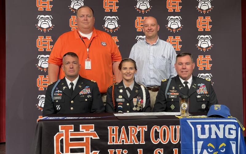 Evelyn Holmes, seated center, signed to the University of North Georgia JROTC program alongside, seated left, Lt. Col. Chris Carter, seated right, Col. Joshua D. Wright from UNG, standing left, principal Kevin Gaines and, standing right, Hart College and Career Academy CEO Brooks Mewborn.