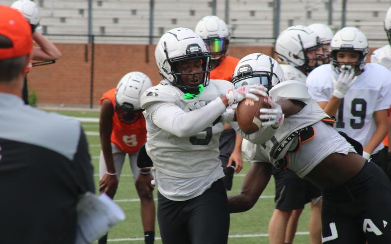 Sunshot by Grayson Williams Rising senior Malachi Kelley hauls in a pass and fights off a defender in a drill during the first day of spring practice at Herndon Stadium on Monday, May 17.