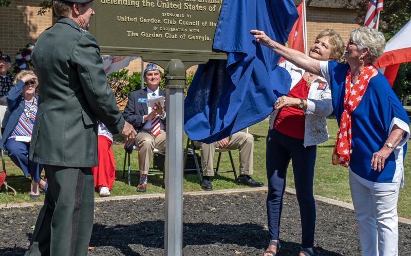 Pictured middle, from left to right, Col. G.T. Myers, Peggy Tucker and Sandra Brown unveil the Gold Star marker.