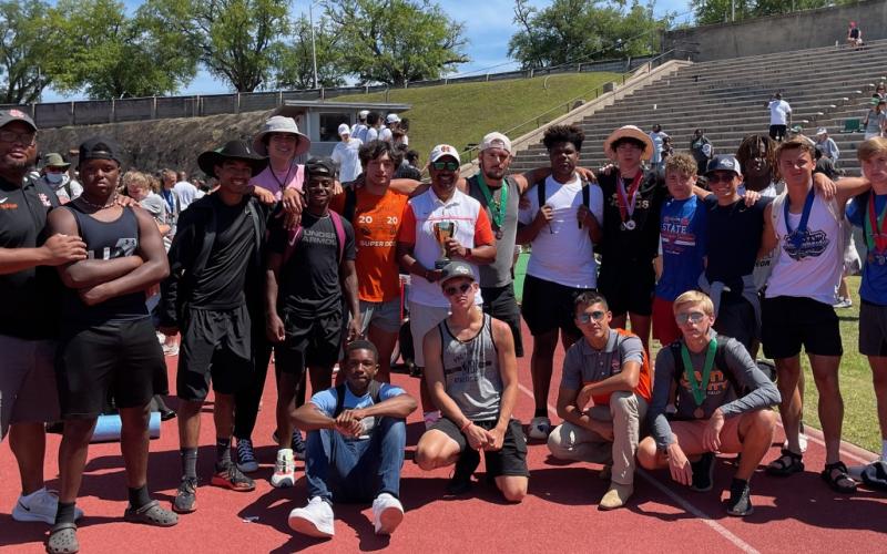 Photo submitted The Hart County boys’ track and field team poses for a photo with its third-place state trophy in Albany. Pictured from left to right are, top row, assistant coach Kendell Rucker, Trez Fouch, Jesse Chlenker, Justin Coker, Quinn Moore, Ty Shiflet, head coach Floyd Ramsey, Damian “D-Rock” Tyler, Kanye Fouch, J.C. Curry, Dominic Dutton, Cole Risner, A.J. Johnson, Chandler Smith, assistant coach Tevin Glaze, bottom row, Johnny Curry, Andrew Brezeale, Diego Martinez and Zachary Peters.