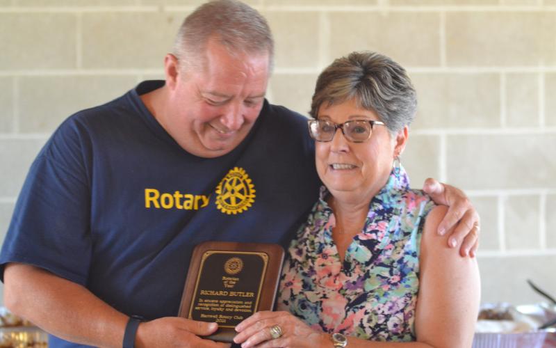 Dan Hunt/The Hartwell Sun - Rotary president Mike Everett hands Nancy Butler the Rotarian-of-the-Year Award. Butler was in attendance to accept the award on behalf of her late husband Dick, the most recent past president, who died June 1.