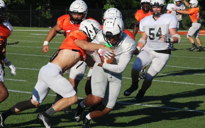 Sunshot by Grayson Williams Rising senior wide receiver Malachi Kelley tries to shake a defender as he grips the football after a catch in the Bulldogs’ spring game on Saturday, May 29 at Herndon Stadium.
