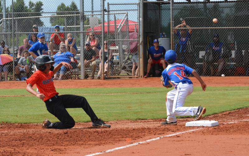 Drew Dotson/The Hartwell Sun - Axel Davis slides safe into third in his team’s win against Toccoa on June 27.