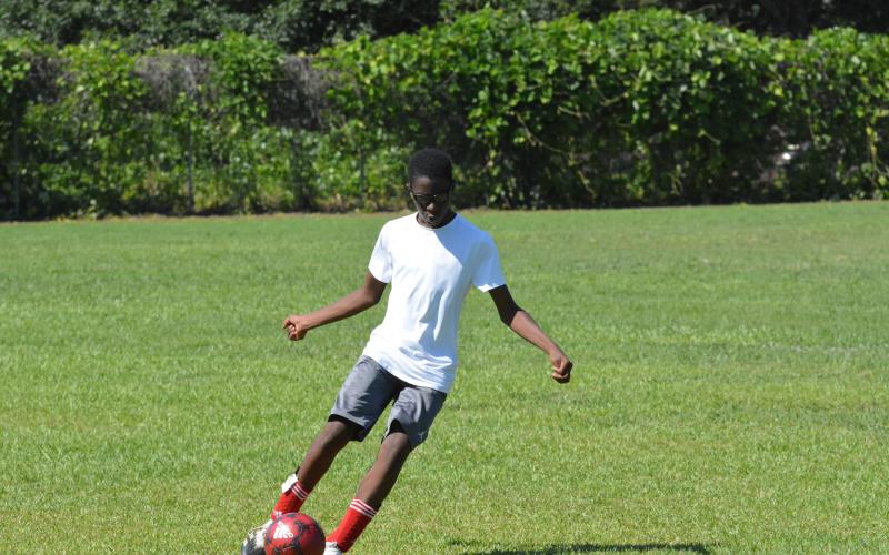 Naim Durham shoots for the goal at the YMCA soccer camp.