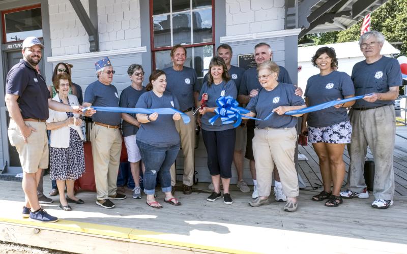 TORCH Board of Directors members cut the ribbon, marking the opening of the train depot and Railroad Street Park.