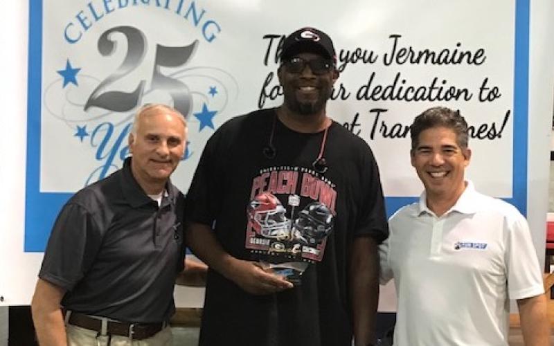 Pictured left to right: Randy Banister COO, Jermaine Gaines, and Bill Wild CEO.