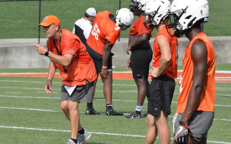 Taz Dixon coaches up his cornerbacks at the first day of practice.