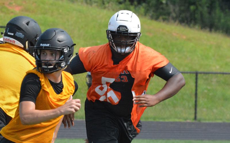 Derrick Clarke stalks a potential pass-catcher coming out of the backfield at the T.L. Hanna camp on July 22.