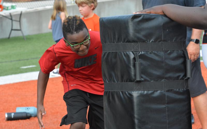 Drew Dotson/The Hartwell Sun - Jonathan Morrison lines to tackle the pad in a defensive line drill.