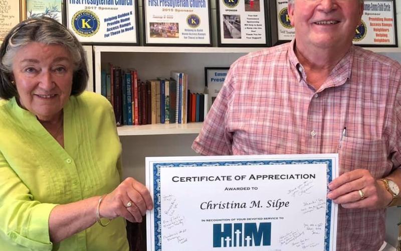 Christina Silpe, left, is handed a certificate of appreciation by Reverend Edwin Simmons for her years of service to Hart Interdenominational Ministry.