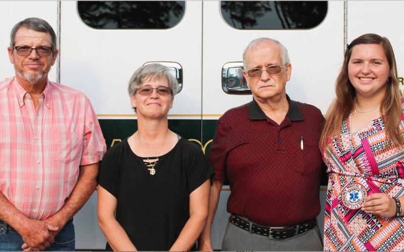Josh Brannen/The Hartwell Sun - Russell Cooper (far left), Brandi Cooper (center left), Randall Dean Graham (center right), and Morgan Cooper (far right), all EMT’s, stand in front of an ambulance.