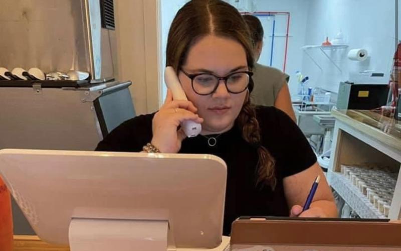 Hartwell Nutrition owner Olivia Holloway takes an order over the phone.
