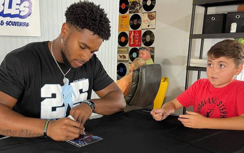 Photo Submitted Kaimon Rucker signs autographs for fans at Lake Hartwell Collectibles on July 31.