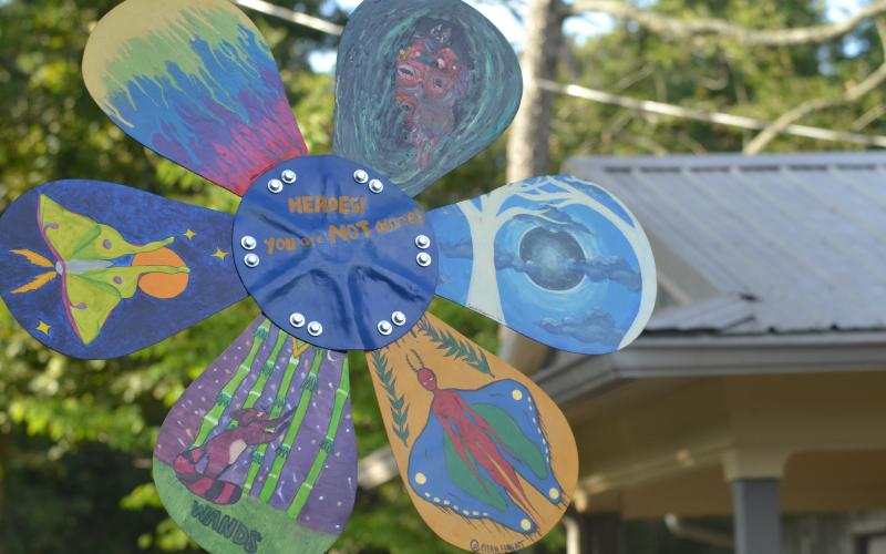 The five-foot tall sculpture features painting work from seven artists, including unique designs on each of the daisy’s six petals.