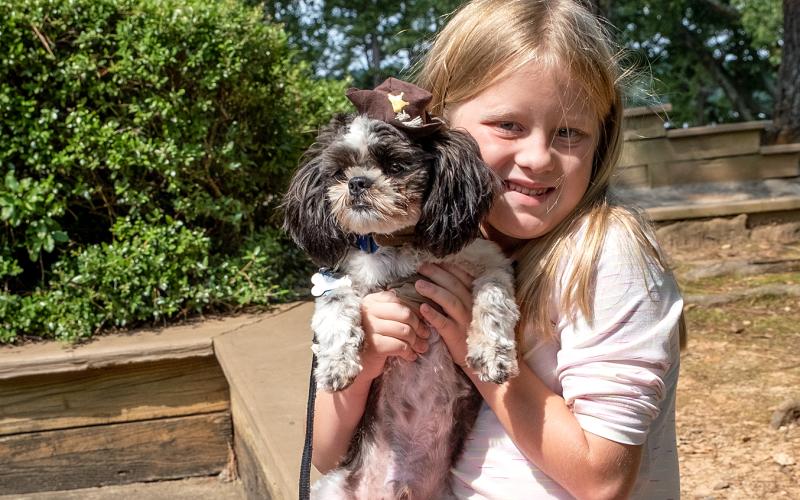 Callie Tucker holds her dog Max.