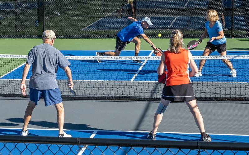Larry Pizarek lunges for the ball as his partner Pat Pizarek prepares for the return at the Fall Fling pickleball tournament this past weekend.