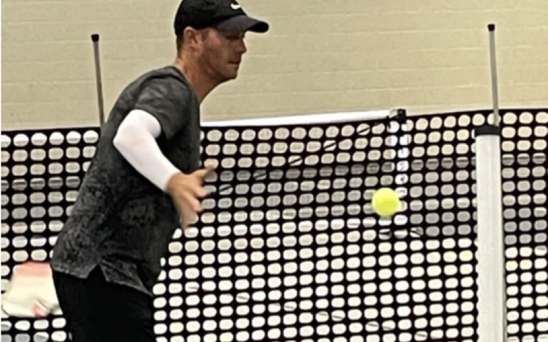 Pickleball pro Mark Price helps students with their technique at the YMCA in Hartwell.