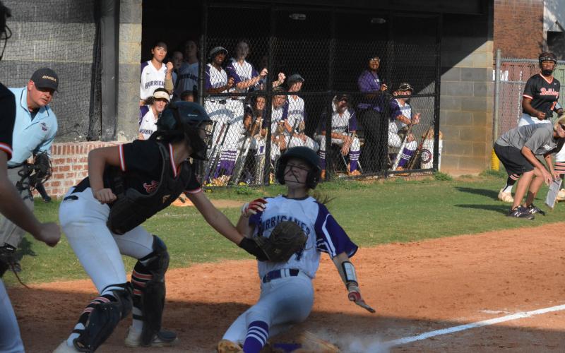 Marlee Harris tags  Monroe Area base-runner out at home on Sept. 10.