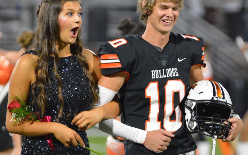 Miss Bulldog Peyton Mewborn hears the exciting news alongside escort Tanner Ayers.