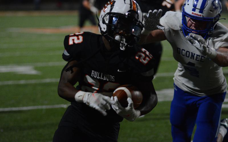 An Oconee defender closes in on running back Nori Moore after a sizable gain on a screen pass.