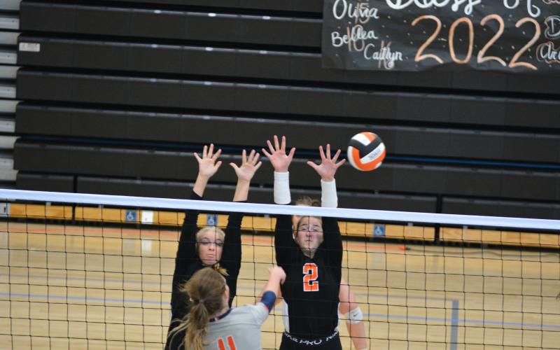 Cali Beebe (left) and Lillie Rogers (right) go up for a block in their last home match on Sept. 23.