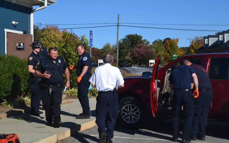 Investigators in first responders check out the scene Monday after a 95-year-old woman drove into the side wall of Hartwell Animal Hospital at 60 Leard Street.