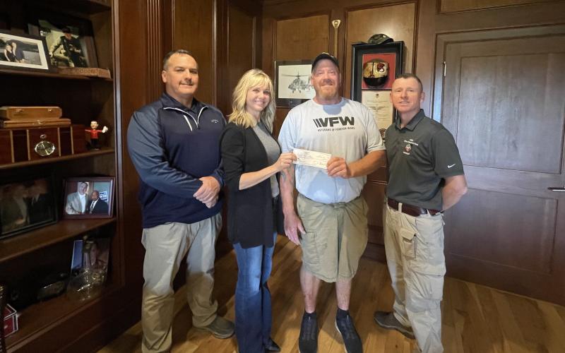 From left to right: Eric Mcallister, post quartermaster; Kelli Schell, chair of the Toughest Kids Board of Directors; Patrick Wireman, post commander and Jud Turpin, post trustee.