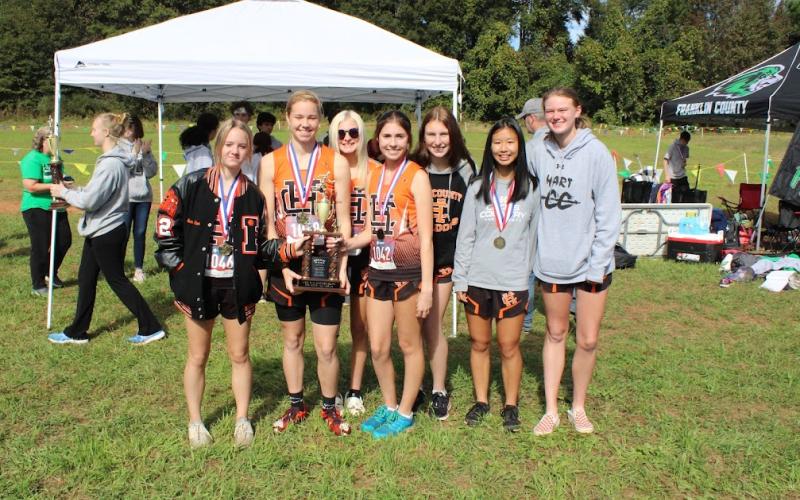 The girls country team pose with their second place trophy after the region meet on Oct. 27.