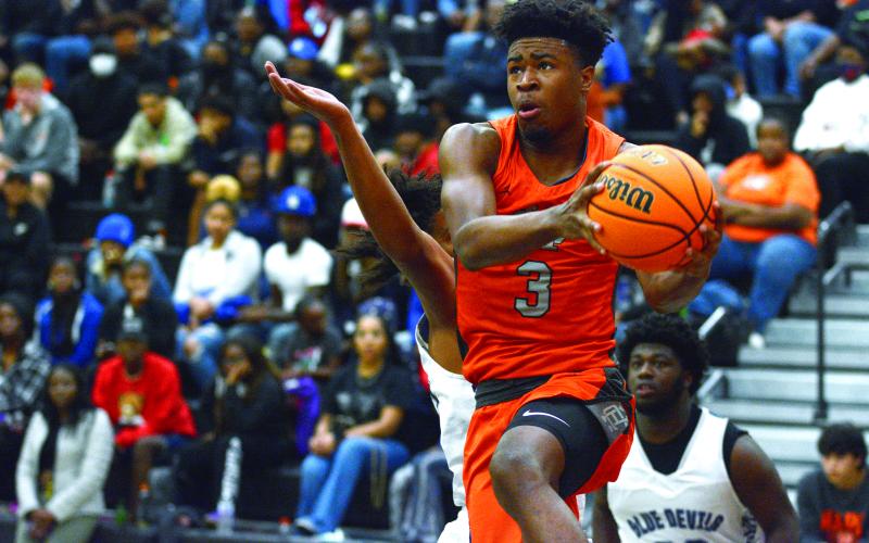 Tahj Johnson flies through the Elbert County defense in their 58-42 victory in front of a packed house on Friday, Dec. 3.