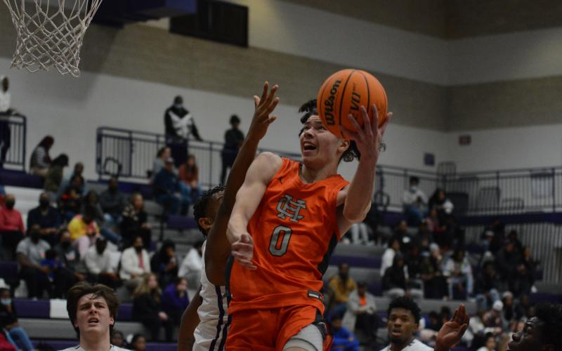 Johnny Curry fights through traffic to get the layup against Monroe Area on Friday, Jan. 7.