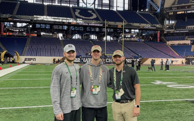 Former Hart County High Schoolers and Georgia football equipment managers (from left to right) Kirby King Carter Banks Preston Mewborn stand field level at Lucas Oil Stadium before Monday night’s national championship game.