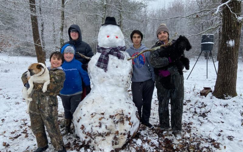 Kids in Hartwell enjoy a rare opportunity to get outside and build a snowman. Pictured from left to right, Tate Oglesby with dog Rocky, Brady Vickery, Blake Vickery, Tucker Oglesby and Payne Oglesby with dog Izzy.