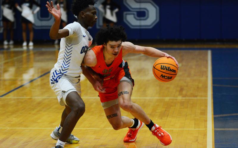 Johnny Curry draws the foul against the Oconee County defender on Tuesday, Jan. 24.